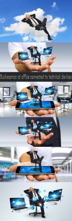 Businessman at office connected to technical devices