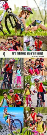 Girls ride bikes on park in helmet